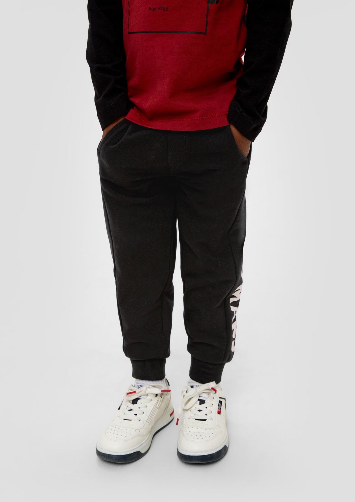 Loose fit: tracksuit bottoms with printed lettering on the side