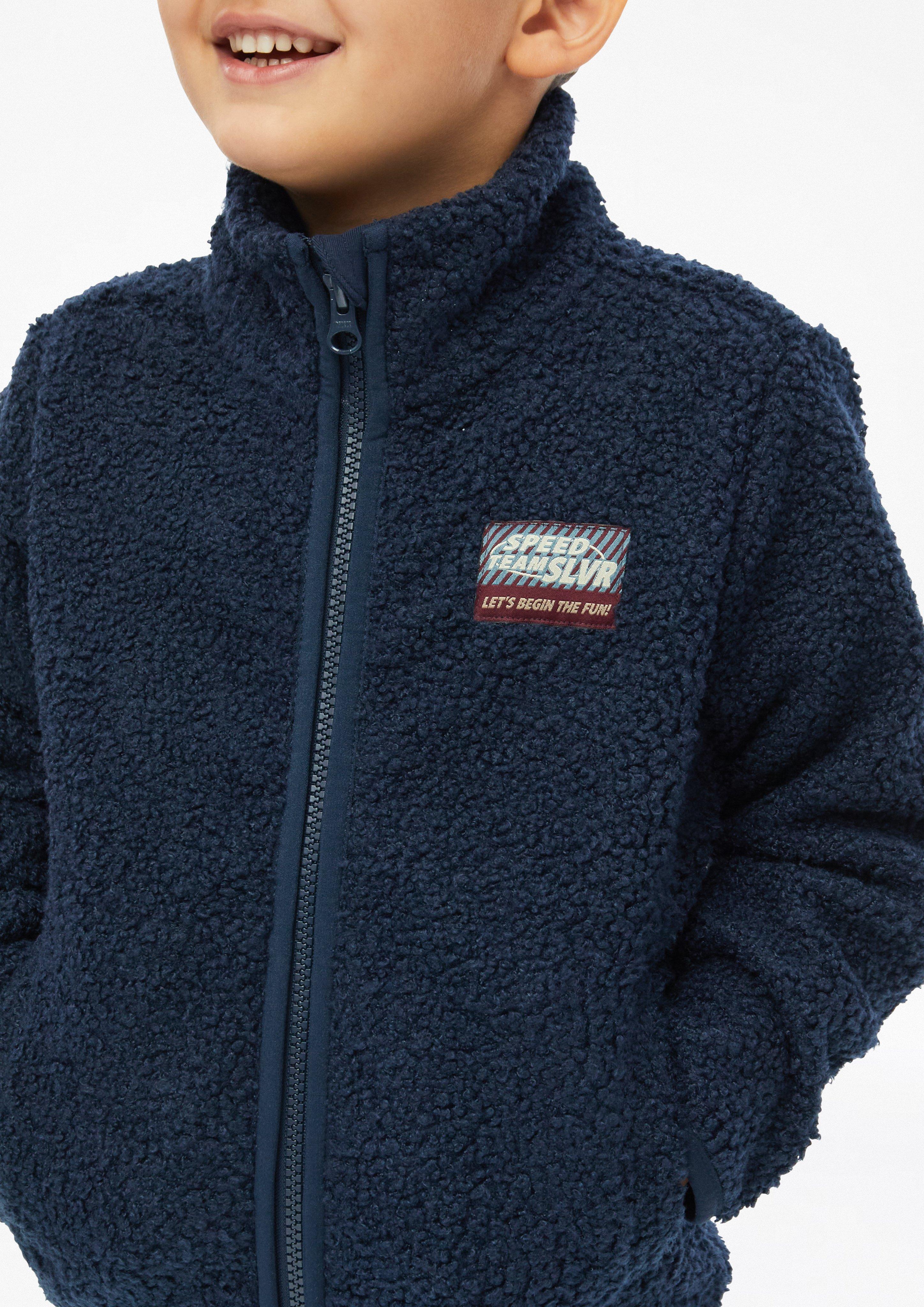 Kids Teddy jacket with stand-up collar and patch in blue by s.Oliver