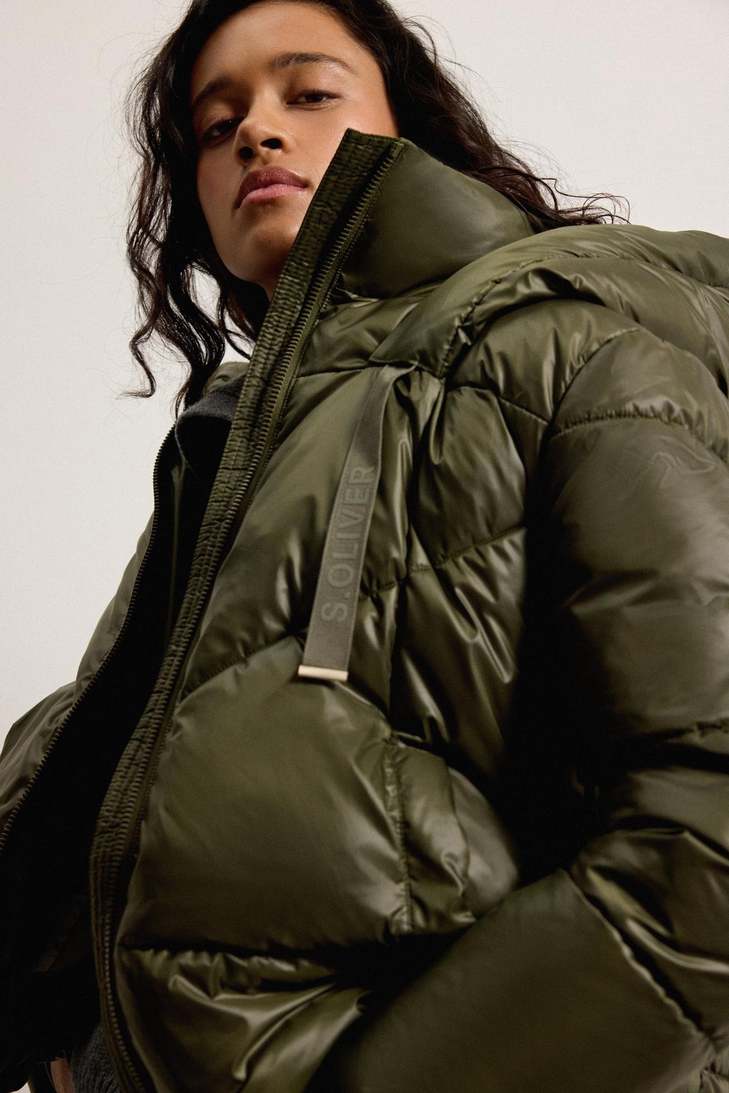 Frau mit grüner Winterjacke